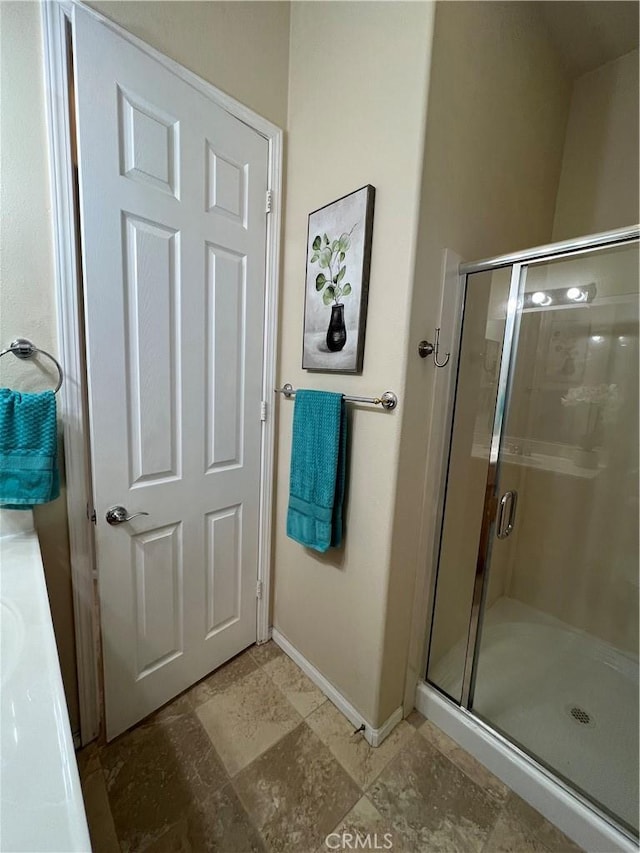 bathroom featuring vanity and a shower with door