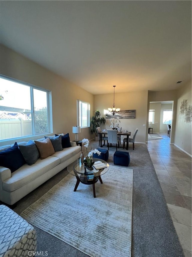 living room featuring tile patterned flooring and a notable chandelier