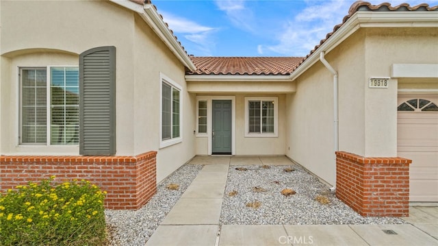 view of exterior entry featuring a garage