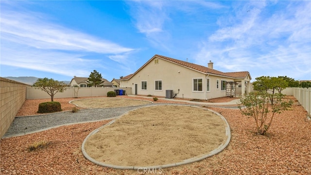 rear view of property featuring cooling unit and a patio