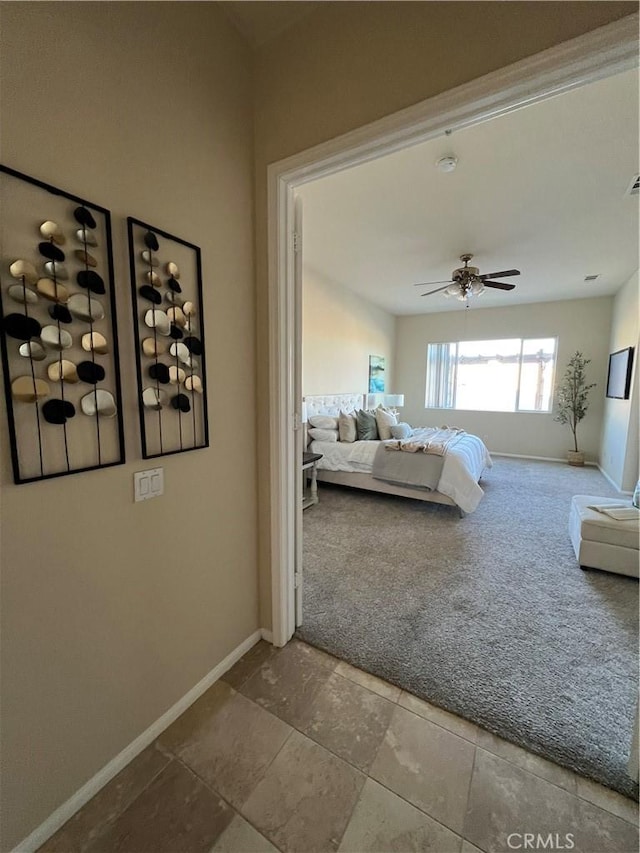 bedroom featuring ceiling fan and carpet flooring