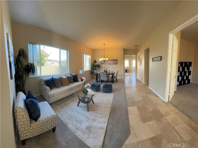 living room featuring light colored carpet, a wealth of natural light, and a notable chandelier