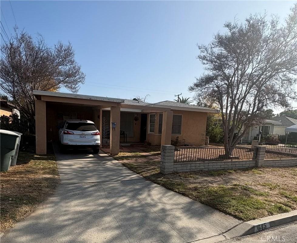 ranch-style house with a carport