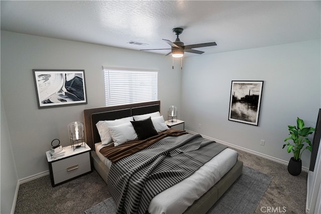 bedroom featuring a ceiling fan, visible vents, dark carpet, and baseboards