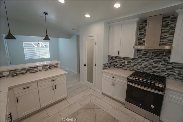 kitchen with white cabinets, decorative backsplash, range with gas cooktop, wall chimney range hood, and pendant lighting