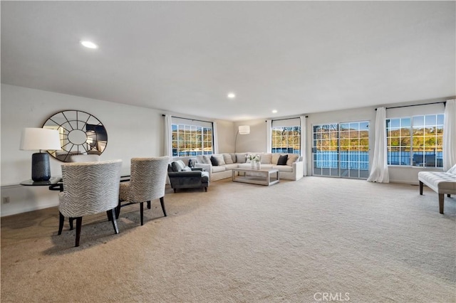 living room with plenty of natural light and carpet flooring