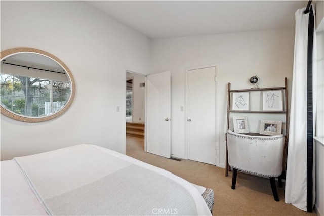 bedroom featuring lofted ceiling and light carpet