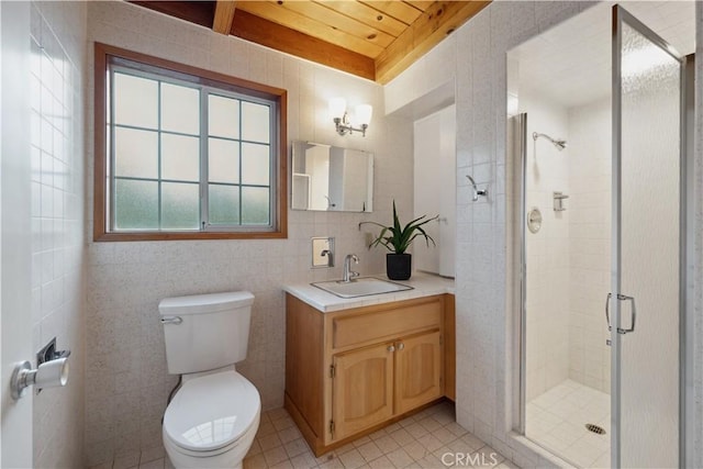 bathroom with tile walls, vanity, tile patterned floors, toilet, and walk in shower