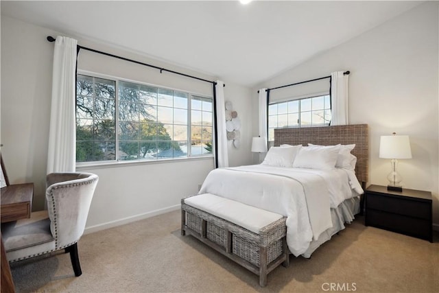 bedroom featuring lofted ceiling and light colored carpet