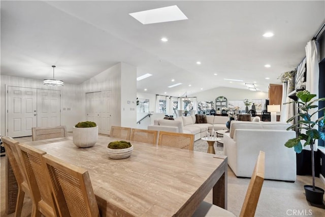 dining space featuring lofted ceiling with skylight