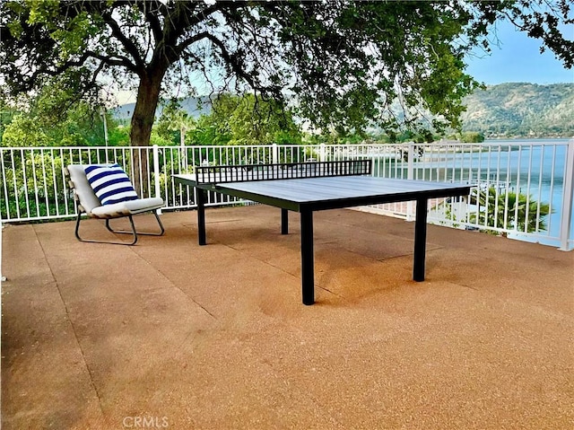 view of patio featuring a water and mountain view