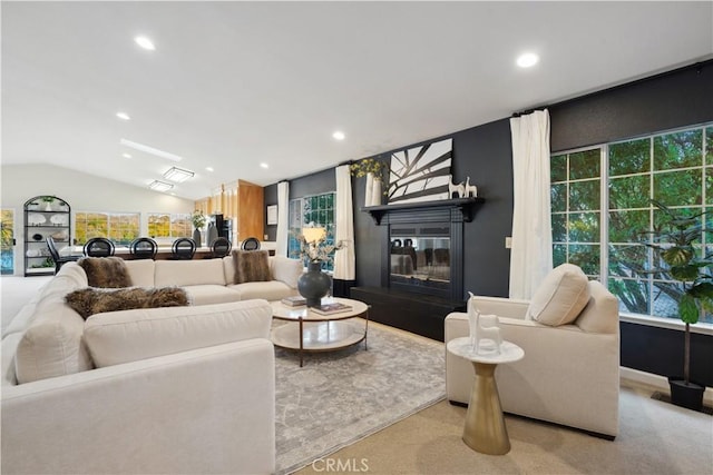 living room with vaulted ceiling and light colored carpet