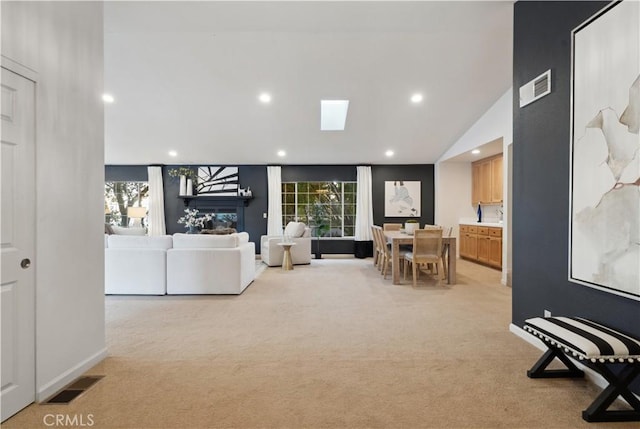 living room featuring lofted ceiling and light colored carpet