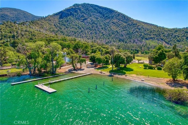 surrounding community with a water and mountain view