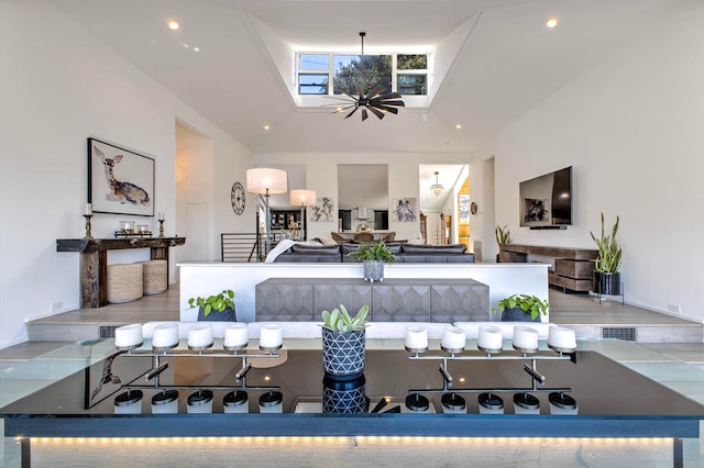 dining space with a skylight and a high ceiling