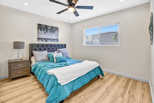 bedroom with ceiling fan and light hardwood / wood-style floors