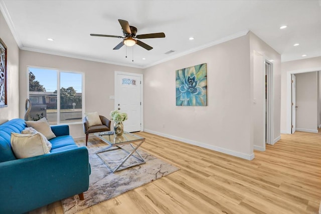 living room featuring crown molding, ceiling fan, and light hardwood / wood-style flooring