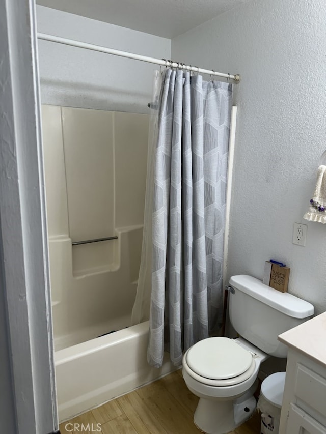 full bathroom with toilet, wood-type flooring, shower / bathtub combination with curtain, and vanity