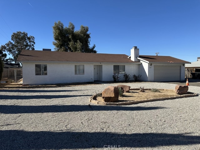 ranch-style house featuring a garage