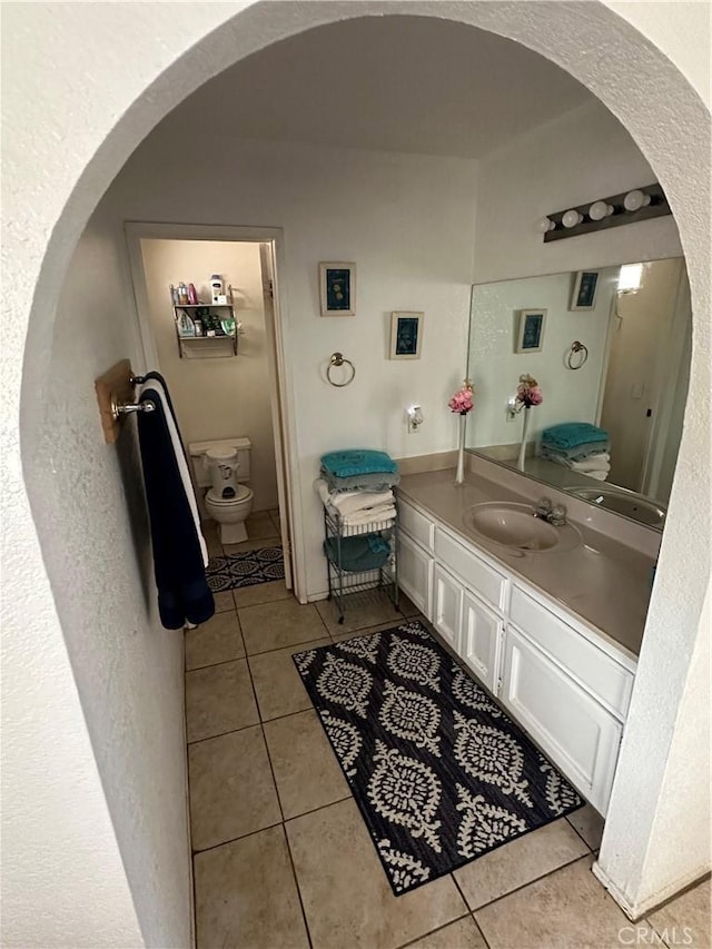 bathroom featuring vanity, toilet, and tile patterned flooring