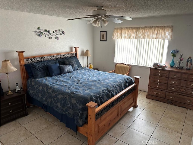 bedroom featuring ceiling fan, a textured ceiling, and light tile patterned floors