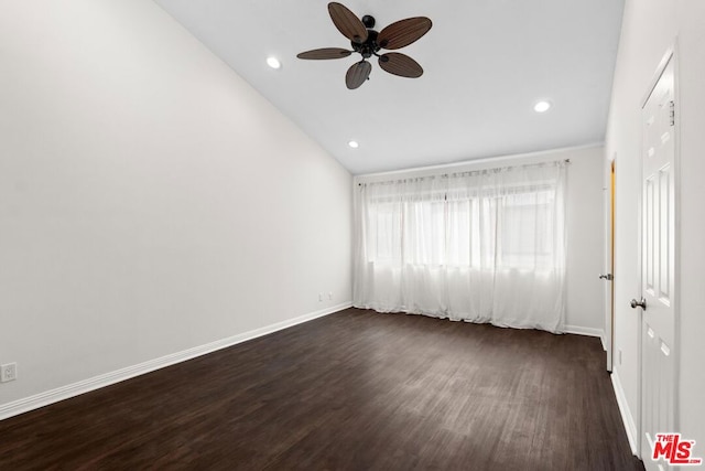 empty room with ceiling fan, lofted ceiling, and dark hardwood / wood-style flooring