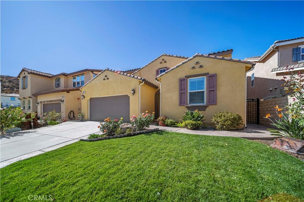 mediterranean / spanish-style home with a front lawn