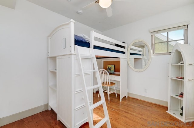 unfurnished bedroom featuring hardwood / wood-style flooring and ceiling fan