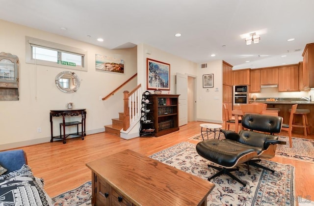 living room with light hardwood / wood-style flooring