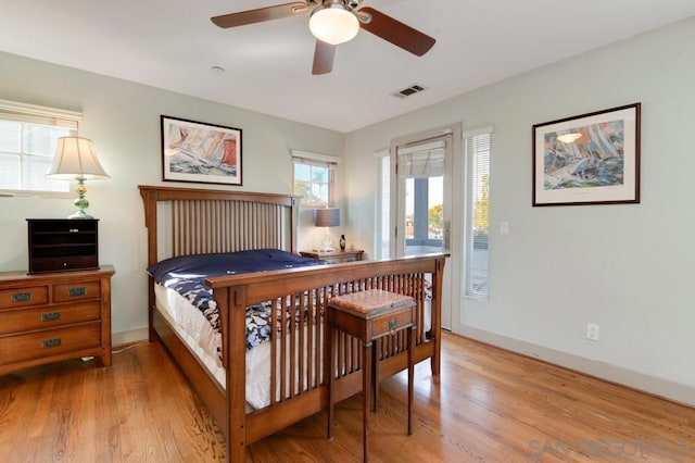 bedroom featuring wood-type flooring and access to exterior