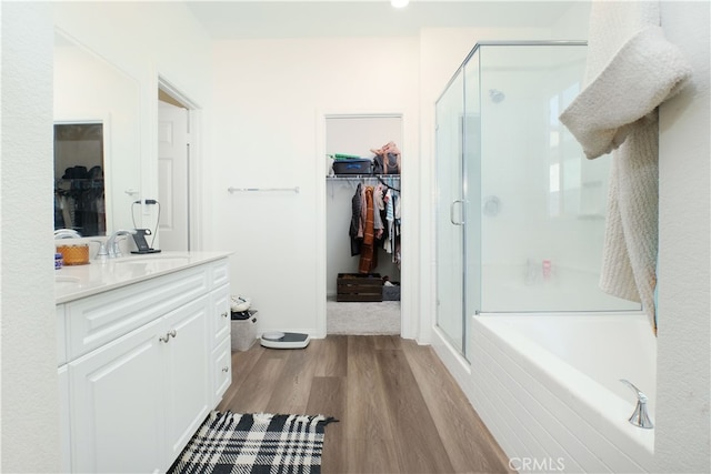 bathroom featuring vanity, hardwood / wood-style floors, and shower with separate bathtub