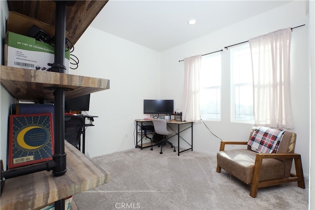 carpeted office featuring a wood stove