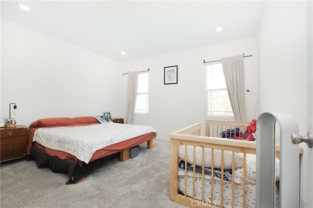 carpeted bedroom with multiple windows