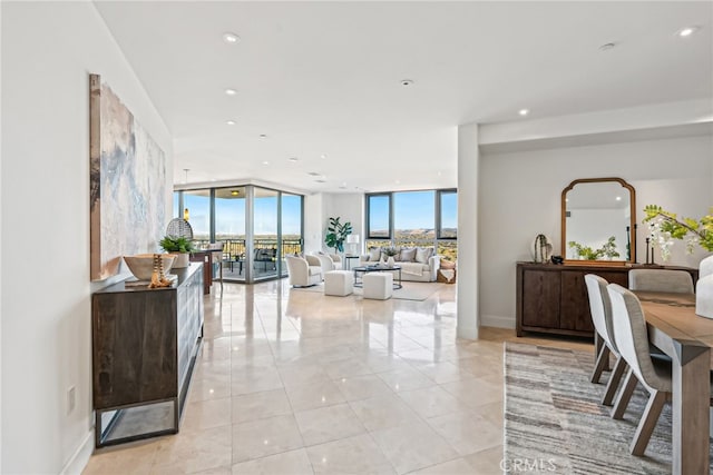 living room featuring light tile patterned flooring, baseboards, floor to ceiling windows, and recessed lighting