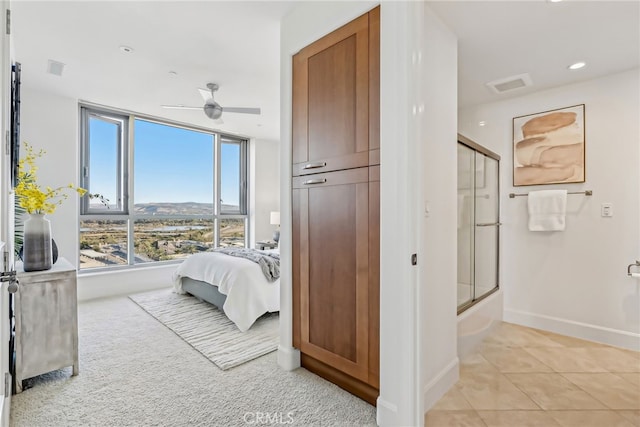 bedroom with light tile patterned floors, a mountain view, recessed lighting, visible vents, and baseboards