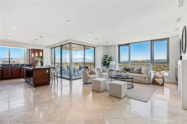 living room featuring recessed lighting, floor to ceiling windows, and light tile patterned floors