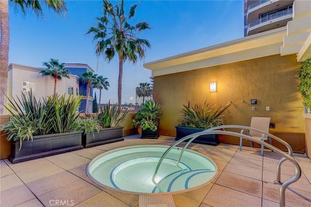 view of pool featuring a community hot tub and a patio