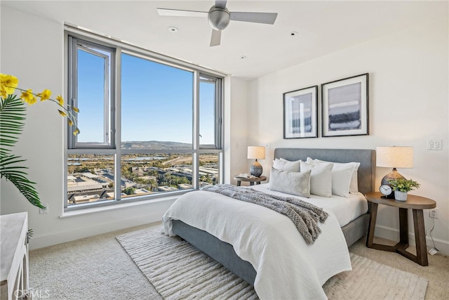 bedroom with light carpet and baseboards