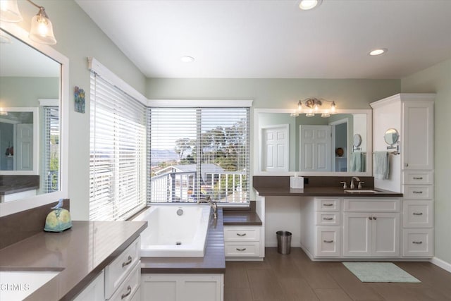 bathroom featuring vanity and a washtub