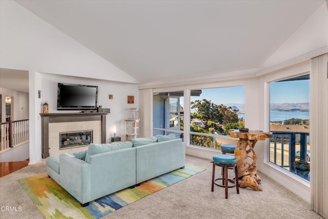 carpeted living room featuring lofted ceiling and a fireplace