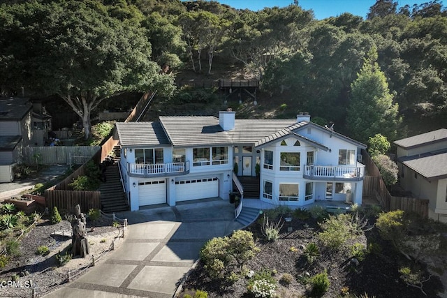 view of front facade featuring a garage and a balcony