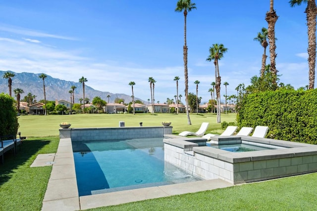 view of swimming pool featuring an in ground hot tub, a mountain view, and a yard