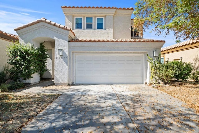 mediterranean / spanish-style home featuring a garage