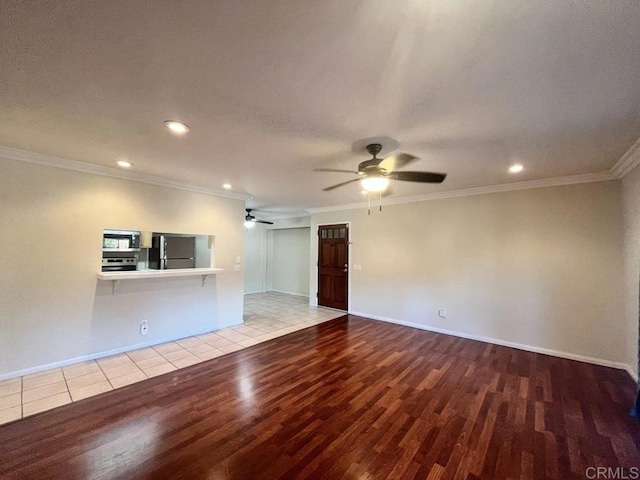 unfurnished living room with light hardwood / wood-style flooring, ornamental molding, and ceiling fan