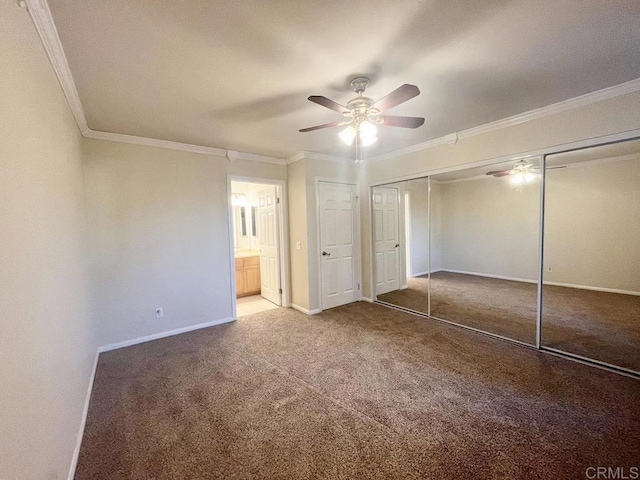 unfurnished bedroom with crown molding, carpet flooring, ceiling fan, and a closet