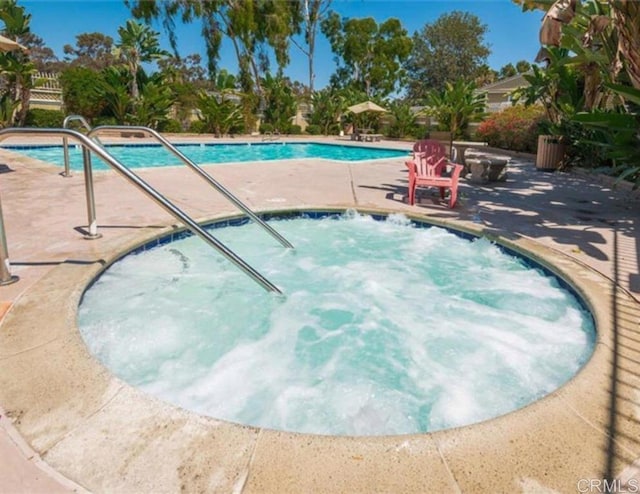 view of pool with a community hot tub