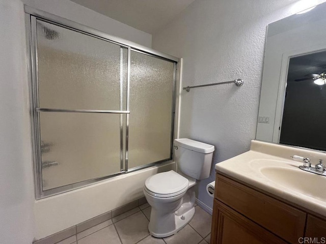 full bathroom with vanity, combined bath / shower with glass door, tile patterned floors, and toilet