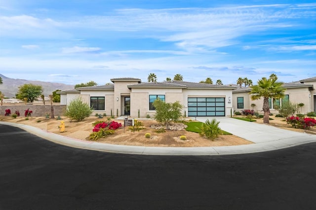 view of front facade featuring a mountain view and a garage