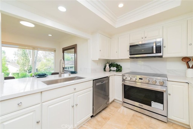 kitchen with sink, crown molding, stainless steel appliances, and white cabinets