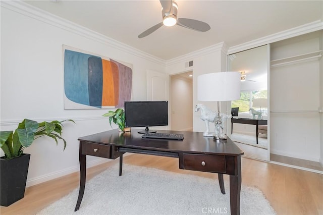 office area featuring ceiling fan, ornamental molding, and light hardwood / wood-style flooring